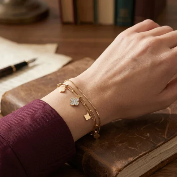 Gold clover charm bracelet for women featuring a delicate chain and clover-shaped charms