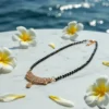 Rose Gold Plated Mangalsutra for Women Rose gold plated mangalsutra for women with a stone-studded pendant and black-bead chain